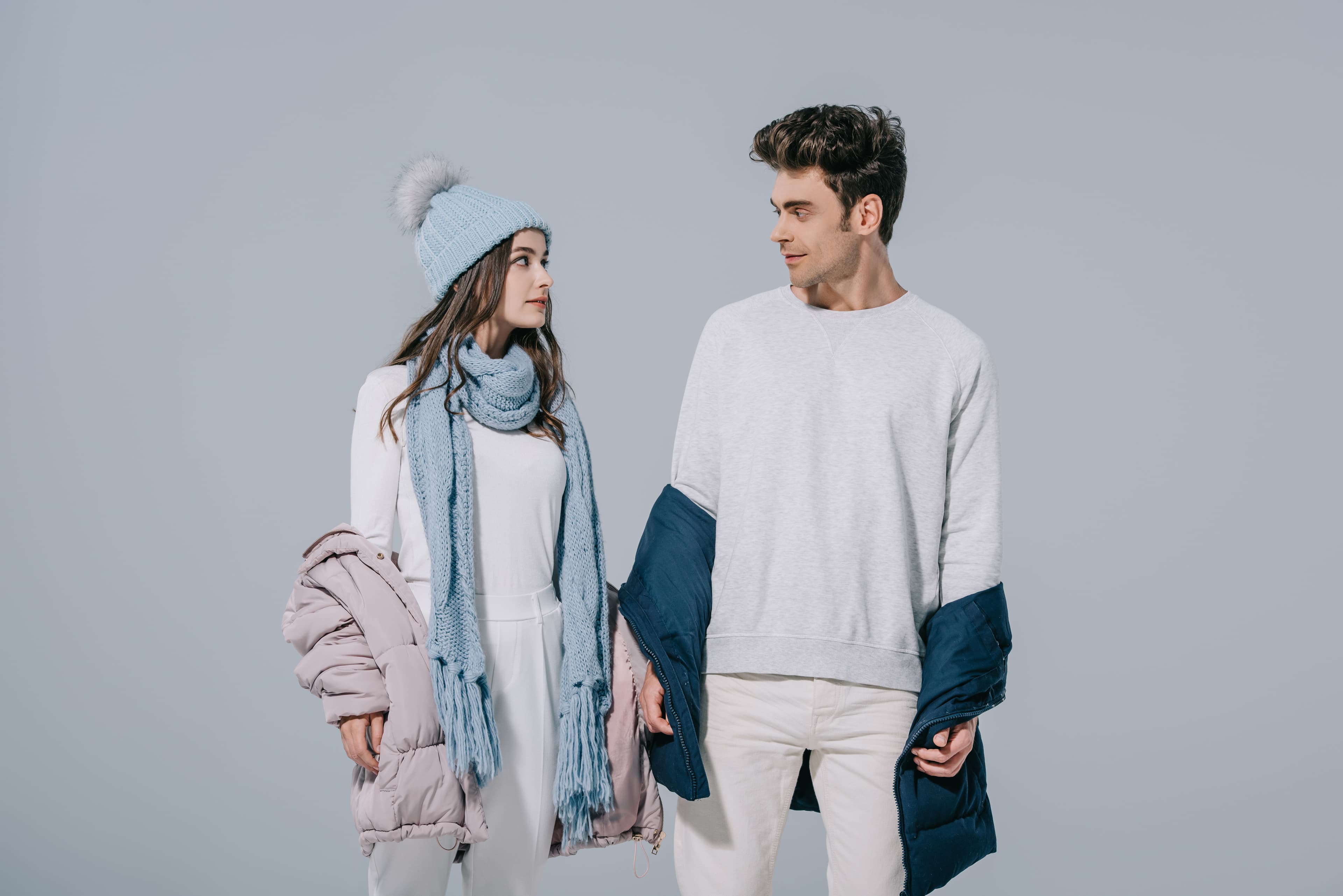 young couple posing in warm winter outfit